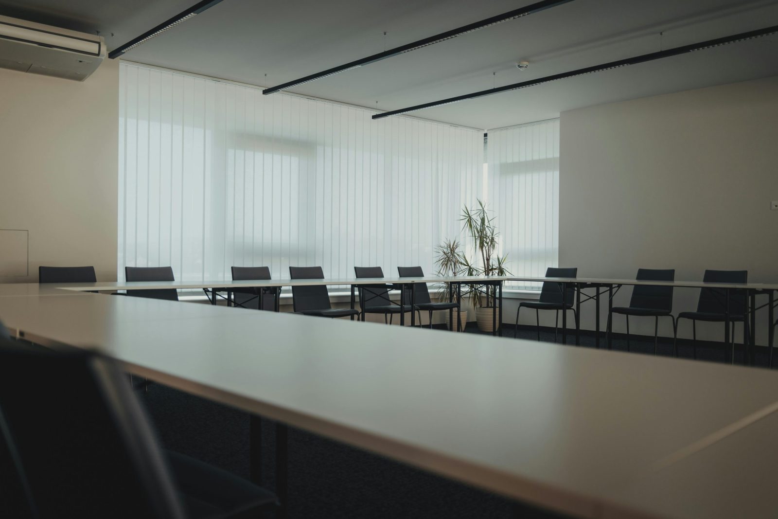Spacious, modern meeting room with large windows and a minimalist design.